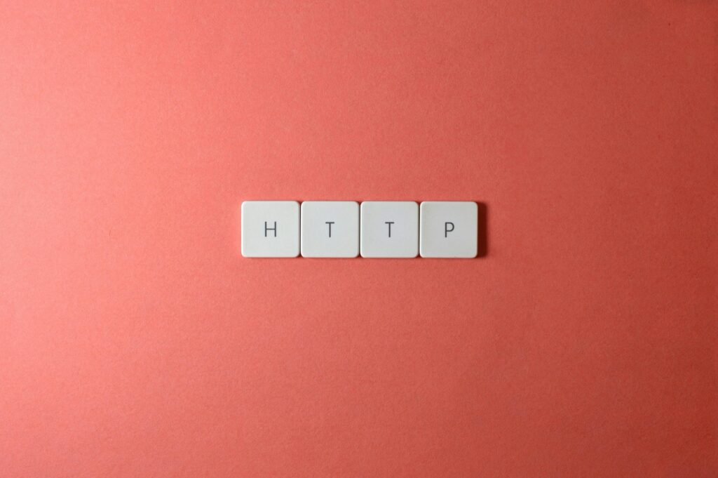 Four white tiles spell out "HTTP" on a coral background.