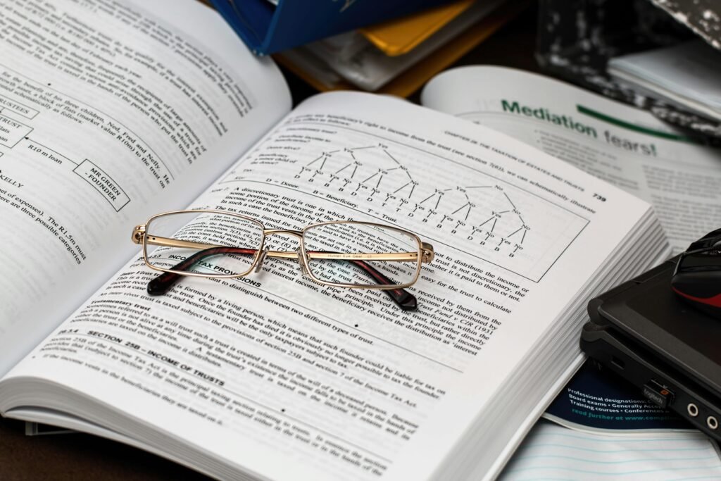 Open books with glasses and a laptop suggest research for SEO Case Studies.