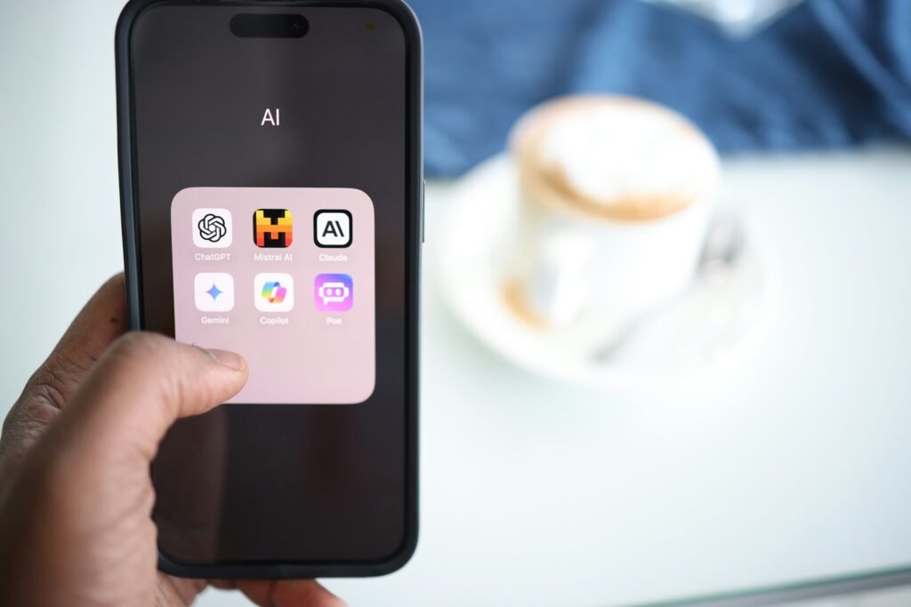 A finger hovers over a smartphone displaying AI technologies to boost website 2025, with a coffee cup in the background.