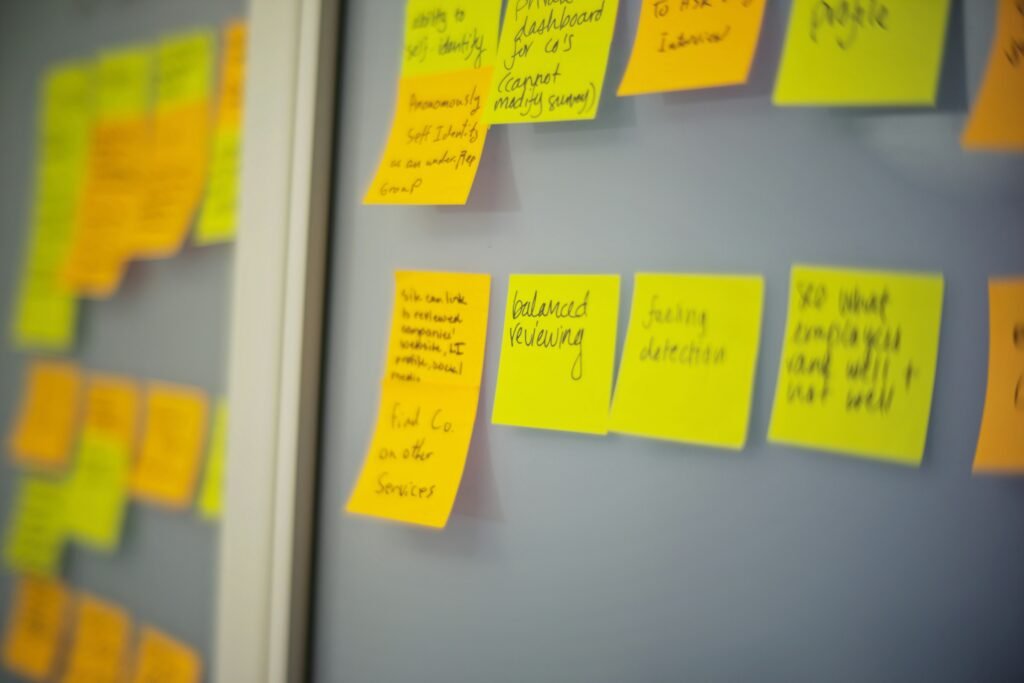 Yellow and orange sticky notes with handwritten text are displayed on a wall, some of which relate to SEO Case Studies.