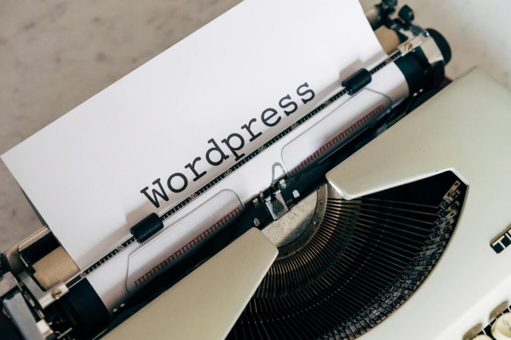 A white sheet of paper with "Wordpress" typed on it is in a vintage typewriter