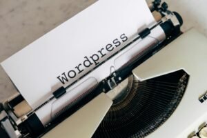 A white sheet of paper with "Wordpress" typed on it is in a vintage typewriter