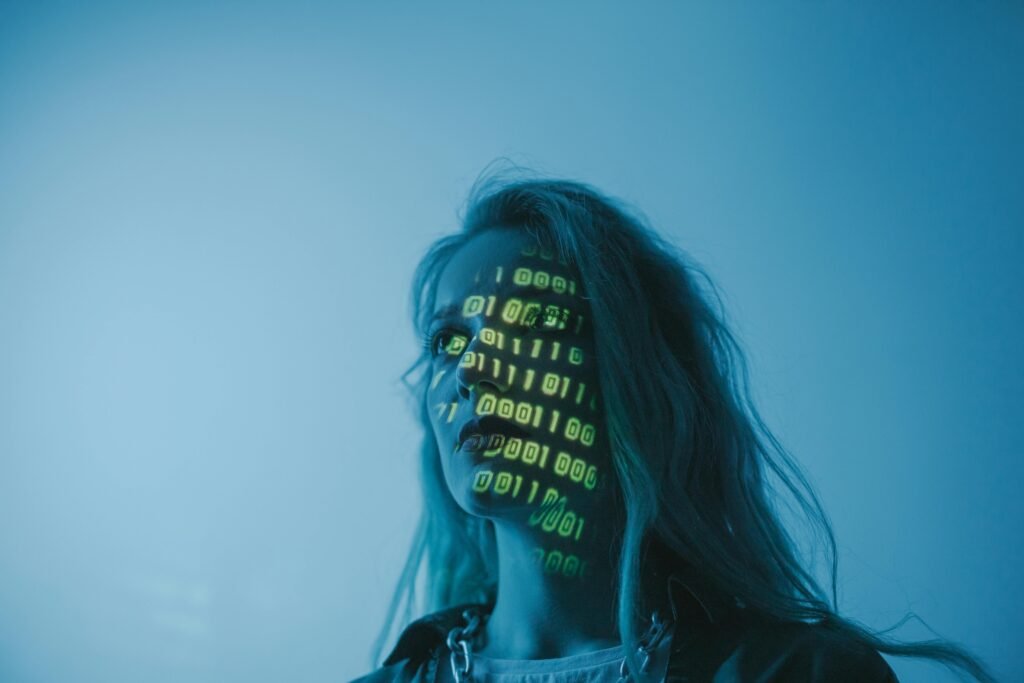 A woman's face is illuminated by projected binary code, hinting at the capabilities of ai alt text generators