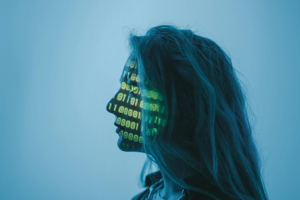 A woman's profile is illuminated by projected binary code, representing ai alt text generators