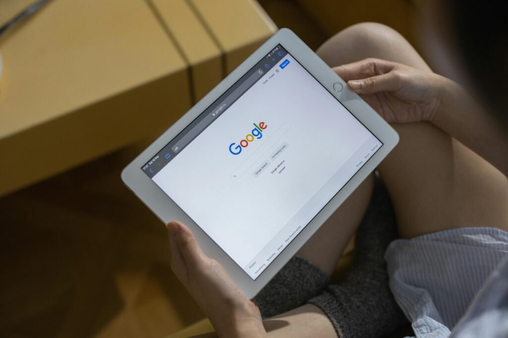 A person holds a tablet displaying the Google search page, relevant to google image search rank