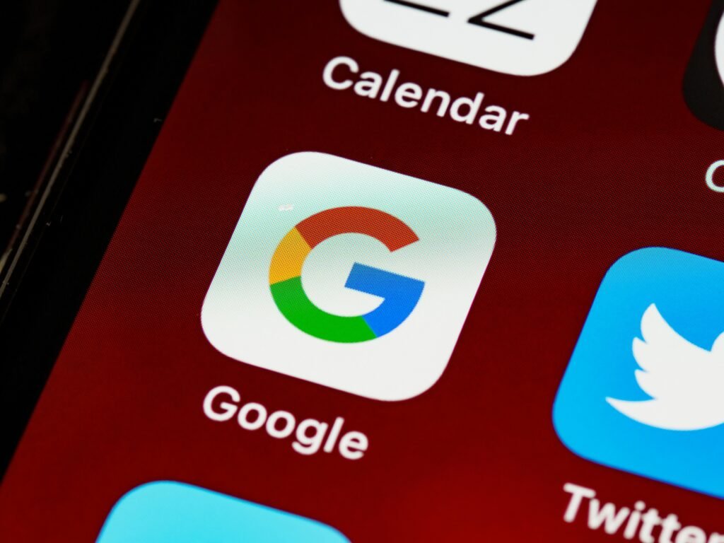 A close-up of a smartphone screen shows the Google app icon and the word "Google" below it, alongside the Calendar and Twitter icons, relevant to boosting google image search rank
